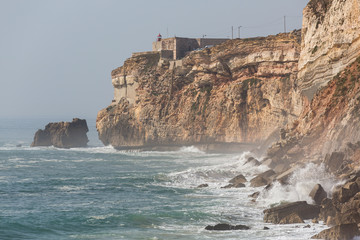 Lighthouse and cliffs at Nazare, Portugal