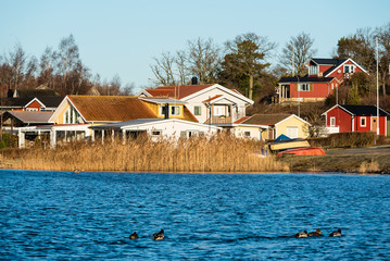 Fototapeta na wymiar Seaside community in coastal landscape on a calm and sunny morning. Location Ekenas outside Ronneby in Sweden.
