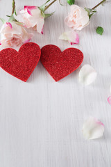 Fototapeta premium Valentine day background, hearts and flowers on white wood
