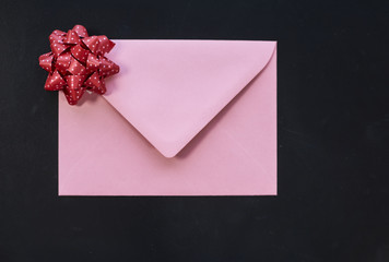 Pink envelope on black background