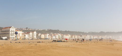 Sunny beach on the Atlantic coast in Nazare, Portugal