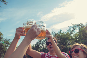 Friends enjoying outdoors with the beer.
