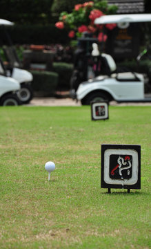 Tee off with golf cart on golf course