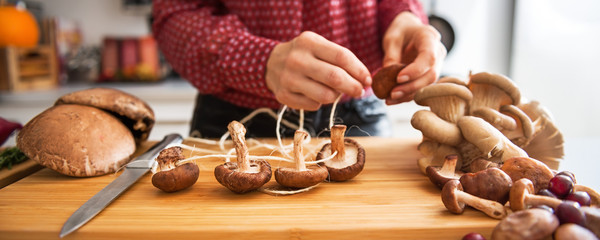 Closeup of mushrooms being strung together