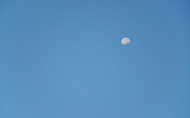 Day moon in blue sky
