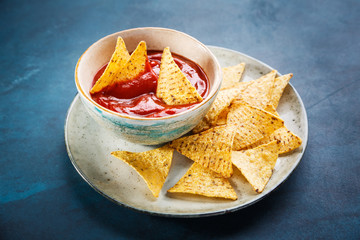 Nachos on plate and red sauce
