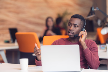 Customer Service agent in an startup office with laptop