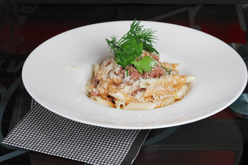 Pasta with tuna and cheese on the table.