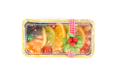 Homemade freshly baked fruitcake in package for Christmas and New year's gift. Dried fruit cake top view, isolated on white background