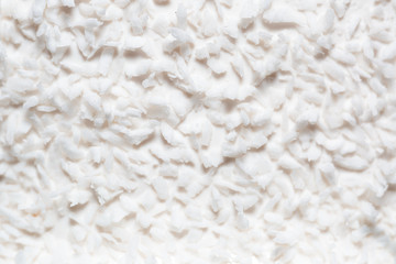 white coconut shavings on the cake.