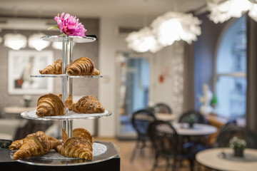 Stand with croissants in the cafe.