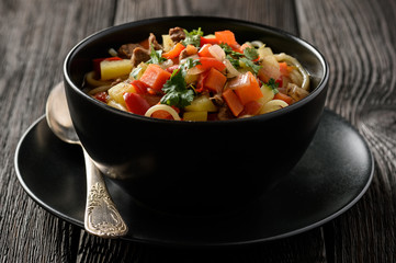 Asian traditional soup with noodles, meat and vegetables known as lagman.
