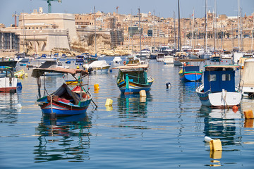 Colored traditional fishing boats (Luzzu) in Marsaxlokk harbor,