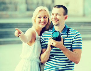 Couple walking with camera