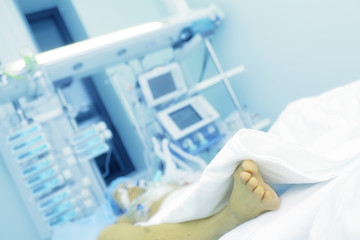 Seriously ill patient in hospital bed