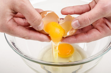 one fresh egg is broken and placed in a glass bowl © Szakaly