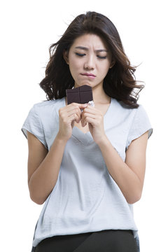 Young woman eating chocolate