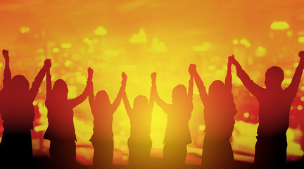 Silhouette of happy business team making high hands in sunset sk