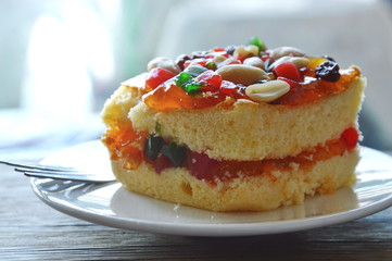 orange butter cake topping peanut and dried fruit salad with fork on dish