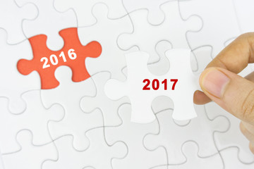 Missing jigsaw puzzle piece with 2016 or 2017 remain word.