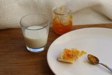 Buns with seeds, jam and milk in a jar, breakfast.