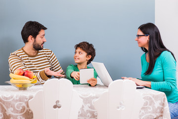 Parents are teaching their son to use computer.