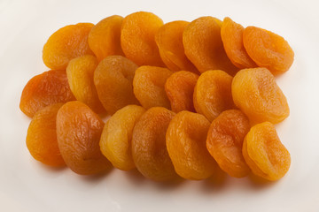 Dried apricots at white plate close-up