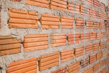 Unfinished brick wall at construction site