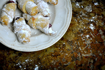 Tasty sweet small croissants on a rustic background