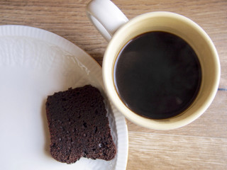 Sliced of chocolate cake with black coffee cup