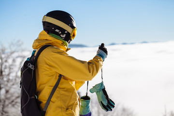 Fototapeta na wymiar Skier taking pictures in the snow on ski slope