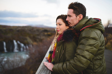 Man and Woman Looking at Waterfall