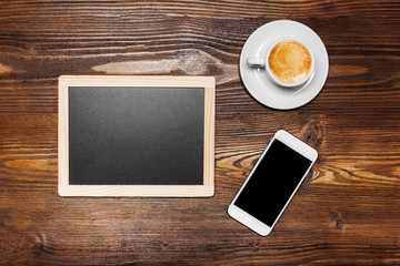 Chalkboard or Blackboard ready for text. Education or working concept. Stylish office background with coffee and mobile phone.
