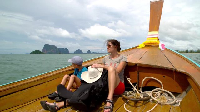 A backpacking mother and son, island hopping in the archipelago of southern Thailand.