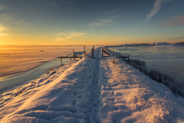 Winter landscape with snow, river, blue sky, road, sunshine, ice. - obrazy, fototapety, plakaty