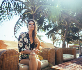 young pretty woman at swimming pool relaxing in chair, fashion l