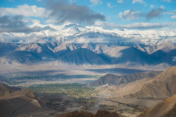 Aerial view of Le-h City, landscape with ice peaks , blue sky in background , Ladak-h, Jam-mu and Kashmir, India