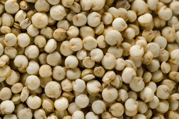 Uncooked raw quinoa. Food background. Healthy lifestyle concept. Closeup macro shot.