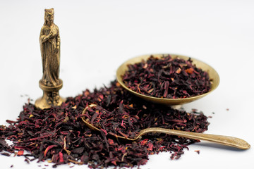 dry hibiscus tea leaves, vintage bronze bowl and spoon with egyp