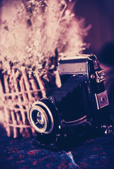 Vintage still life with old camera and wooden vase