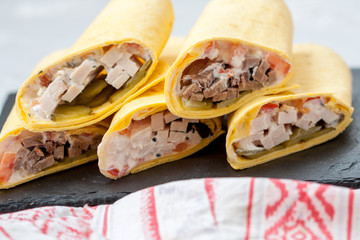 Various of tasty tortilla wraps on dark slate. Healthy street food
