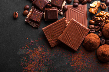 Variety of sweet homemade chocolate pralines on wooden background