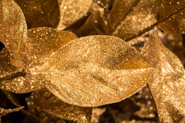 Golden background with Christmas decorative leaf. 