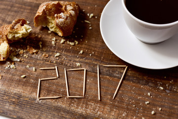 croissant, coffee and number 2017, as the new year