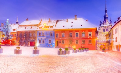 Naklejka premium Christmas market and decorations tree in the main center of Sighisoara town, in winter season, Romania