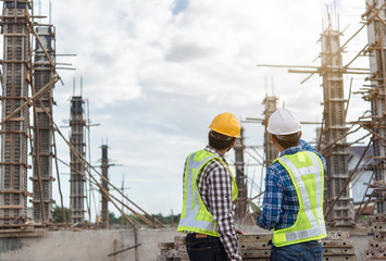 Two young man architect on a building construction site
