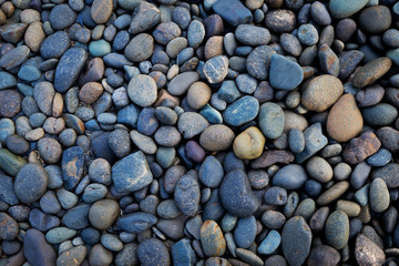 Stone with different sizes and color from the beach background