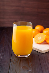 Orange juice on wooden background