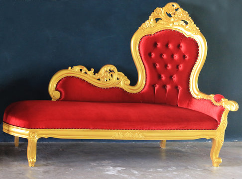 Concept of luxury with red velvet and gold armchair