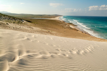 Fototapeta na wymiar Human footprints on the white sand of Deleisha beach